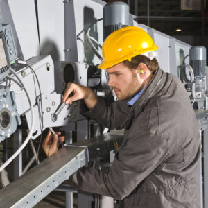 A male maintenance engineer at work on an industrial appliance